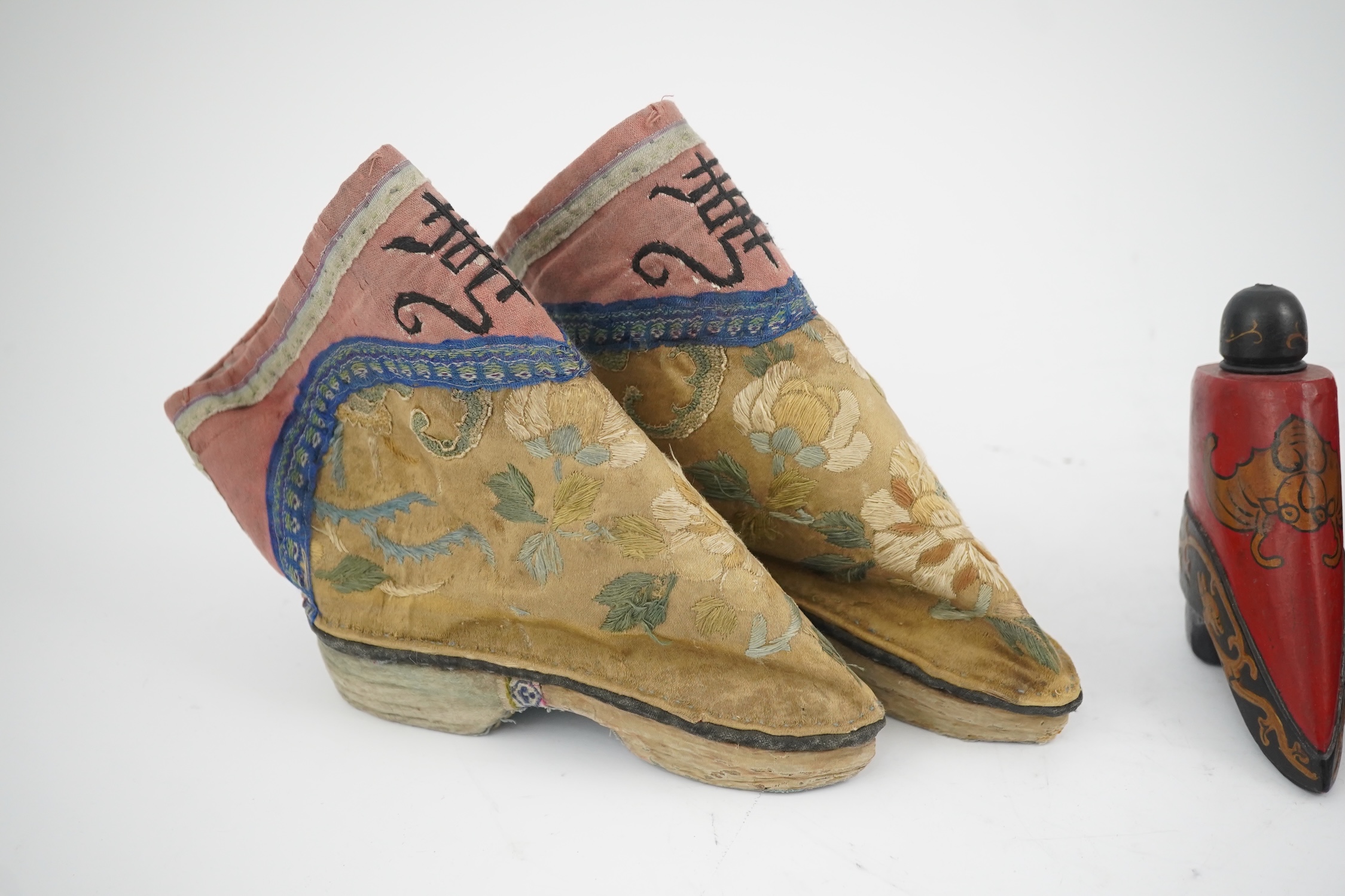 Three pairs of late 19th / early 20th century Chinese ladies embroidered silk shoes, for bound feet, one with sheep’s wool pom-poms, together with a similar a pair of silk embroidered ankle boots and pair of decorative r